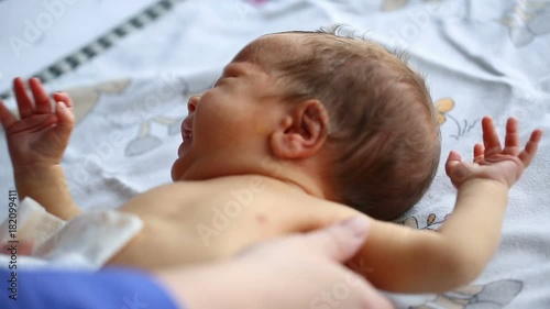 Newborn having his diaper changed and crying during this process
