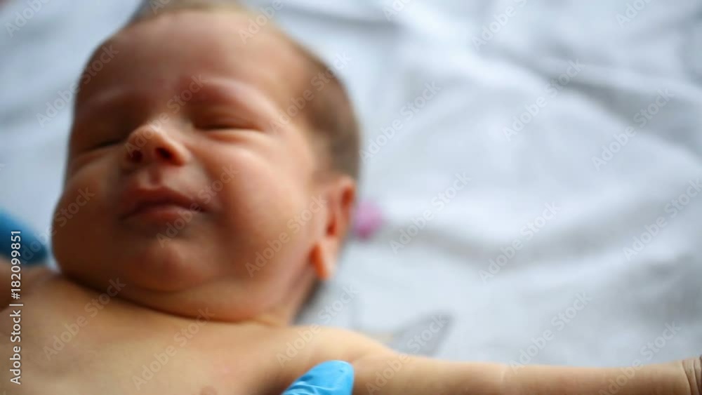 Doctor takes newborn baby and wearing gloves
Doctor takes newborn baby and wearing gloves