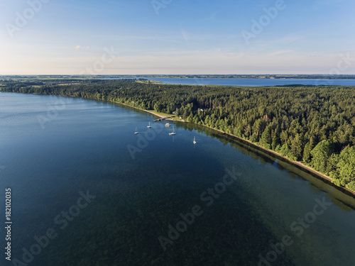 Aerial view over big lake Dusia in Lithuania, during sunny summer day. photo