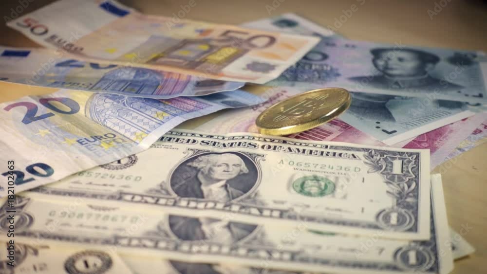 Golden bitcoin coin falling over Dollar, euro and yuan bills. Financial concept. Situation of Bitcoin and other cryptocurrencies in the real world Golden bitcoin coin falling over Dollar, euro and yuan bills. Financial concept. Situation of Bitcoin and other cryptocurrencies in the real world