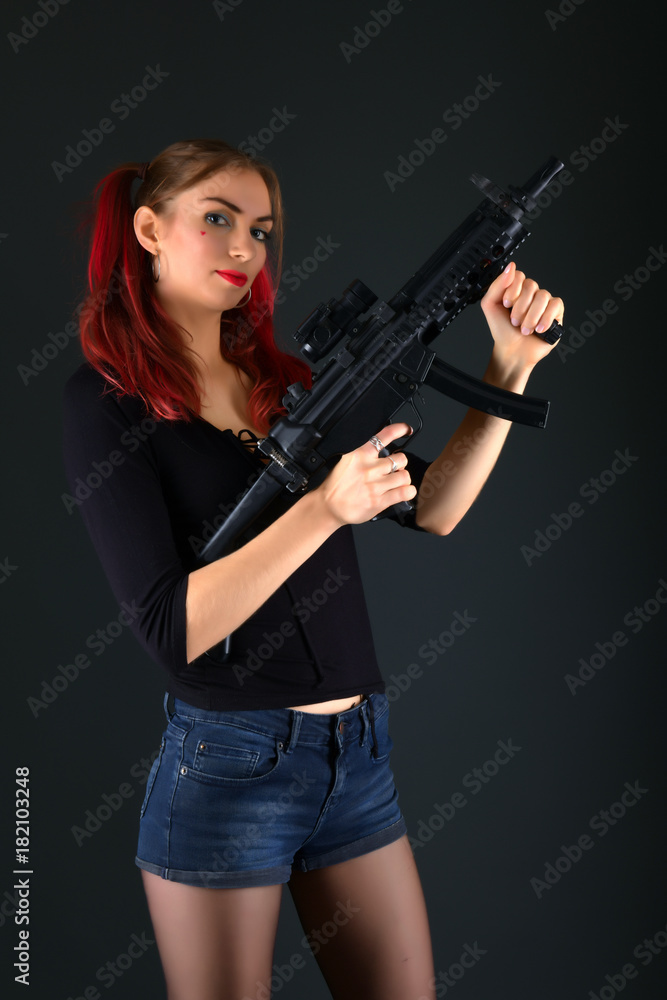 Sexy model woman with a gun. 