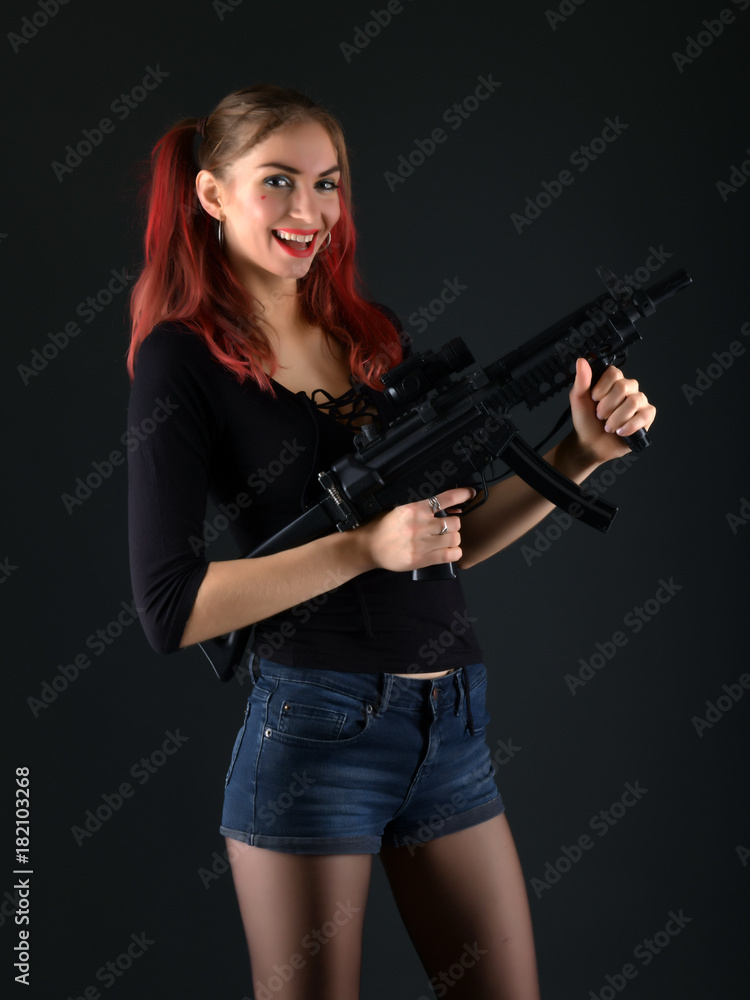 Sexy model woman with a gun. 