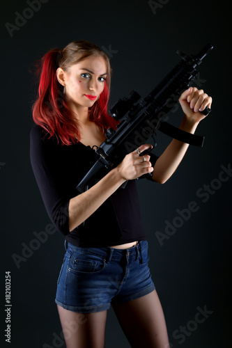 Sexy model woman with a gun. 