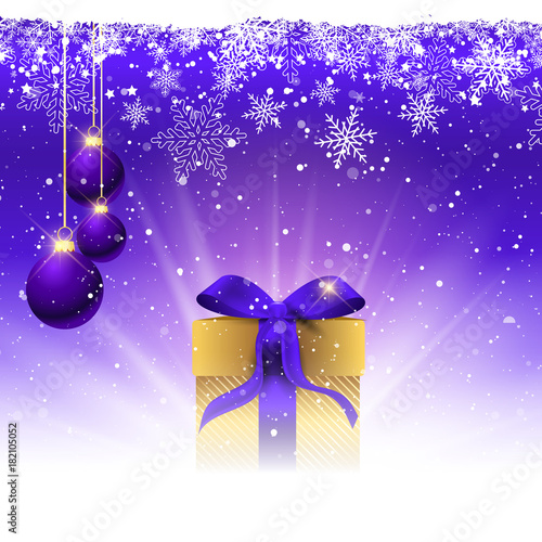 Christmas gift with purple ribbon nestled in snow
