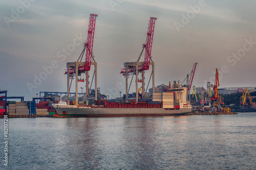 Port cranes and a ship on unloading. Sea transport