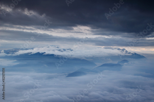 Jagged ridges of Julian Alps, Sava valley and Pokljuka plateau blanketed in sea of low level clouds and fog in autumn morning, Triglav National Park, from Stol peak Karavanke mountains Slovenia Europe