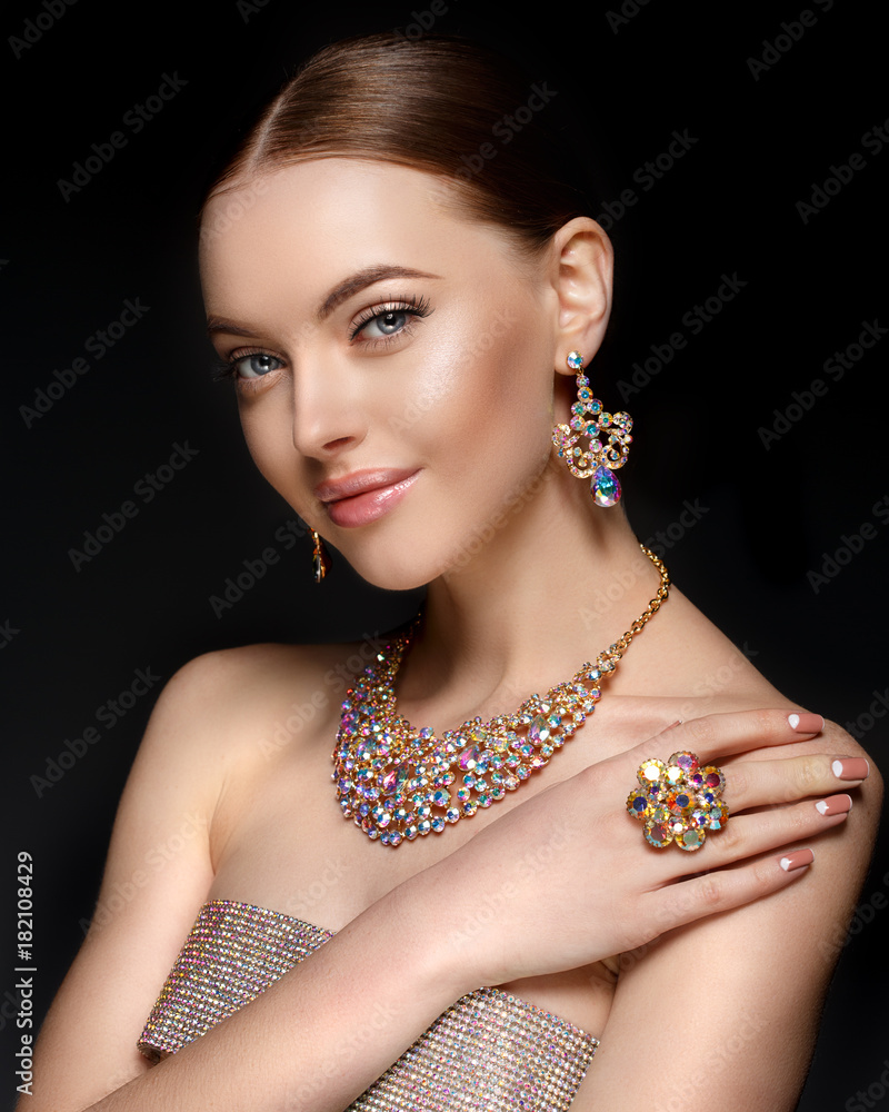 Model in set of jewellery. Luxury girl in shine jewelry from precious  stones, diamonds. Beautiful woman in a necklace, earrings and big ring.  Beauty and accessories. Stock Photo