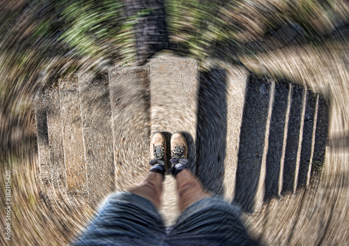 Hiker in boots at top of dual staircase with radial spin, concept image