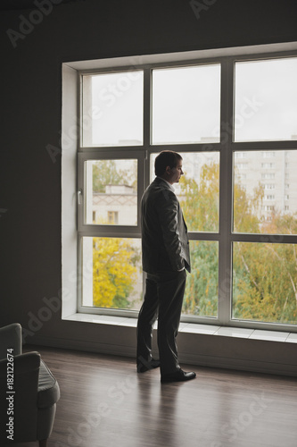 The young man in front of a huge window 142.