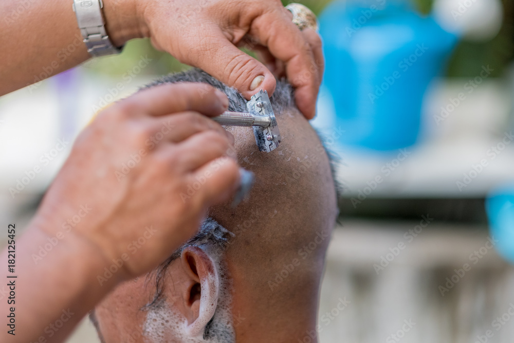 Buddhist monks shave their hair to be ordained a priest.- (Selective focus)