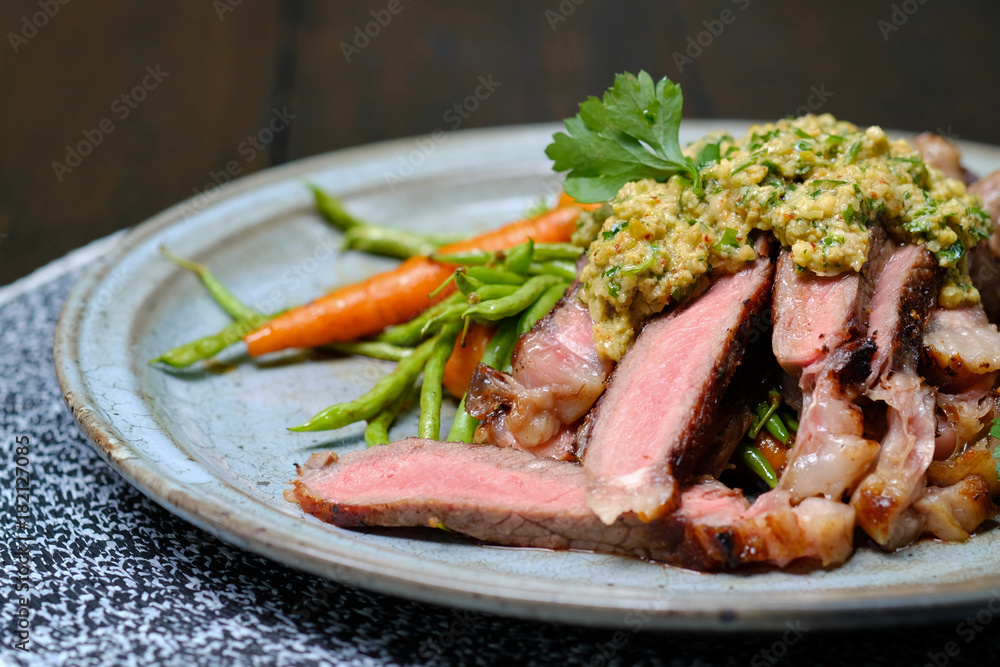 Close up Steak with Green Olive Pesto. (selective focus) Close up Steak with Green Olive Pesto. (selective focus)