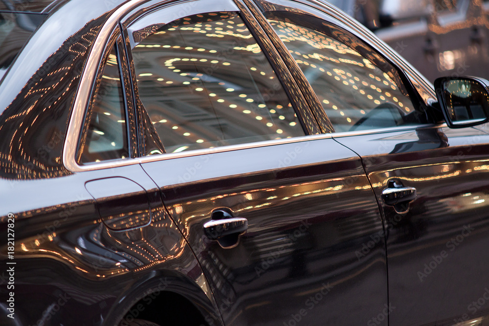 beautiful car with reflection of illumination on the surface beautiful car with reflection of illumination on the surface