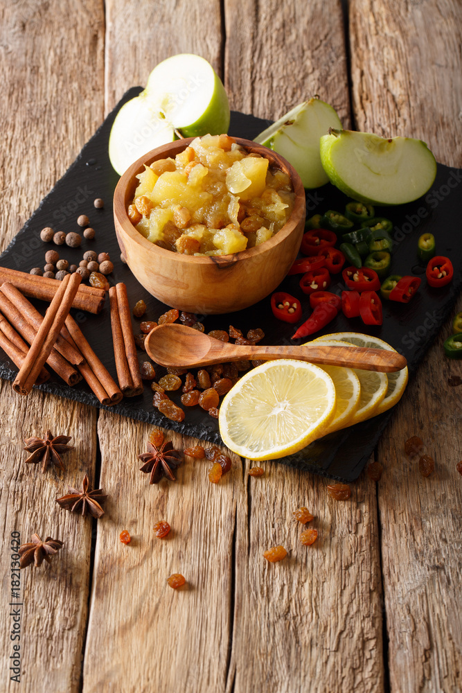 Indian apple chutney with ingredients close-up on the table. vertical
