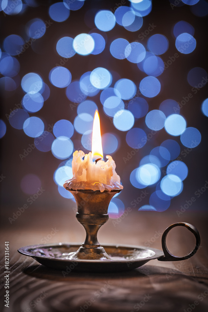 Fototapeta premium vintage candlestick with candle on blurred background