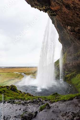 wet path inside of Seljalandsfoss waterfall