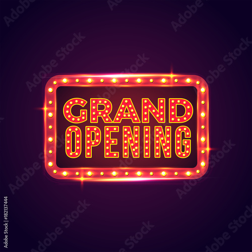 Grand opening sign board with marquee lights on purple background.