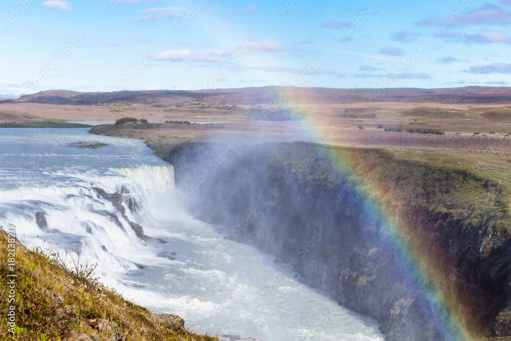 rainbow over Gullfoss waterfall in canyon