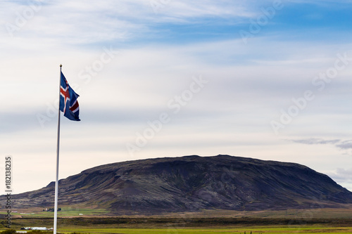icelandic flag and view of hill in Iceland