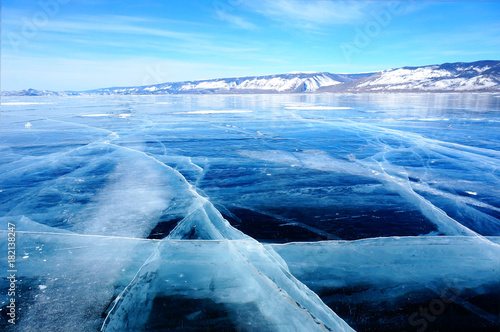 Frozen ice hummocks and ice cracks with blue sky during winter in Lake Baikal, Siberia, Russia