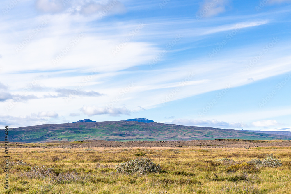 blue sky with white clouds over icelandic meadow