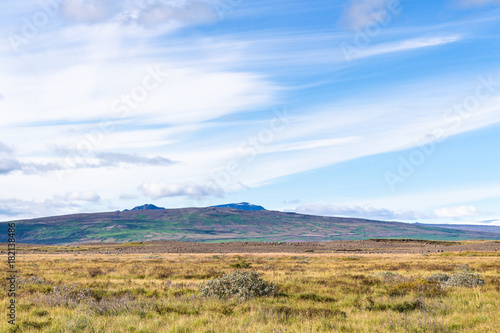 blue sky with white clouds over icelandic meadow