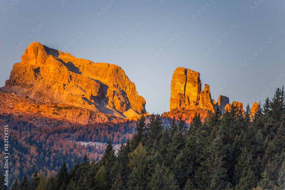 View of Five Towers Peaks (Cinque Torri) at sunrise from Falzarego pass in an autumn landscape in Dolomites, Italy.