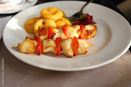 The kebab of pork with pepper and garnish of potato bagel