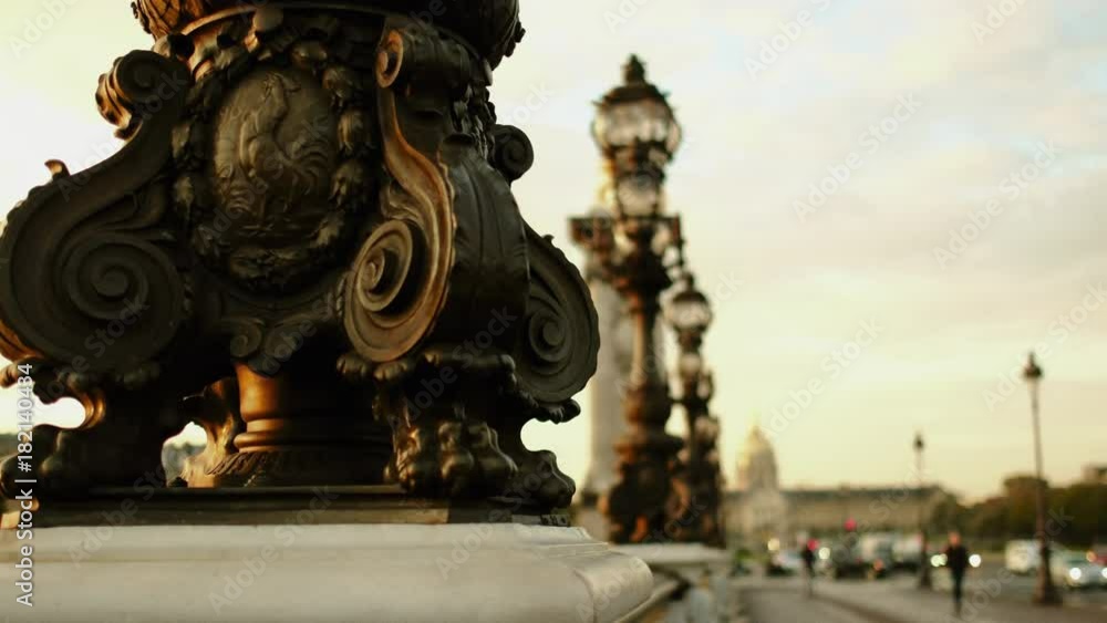 A detail of the famous Pont Alexandre III in Paris. Passengers are walking by watching the city. 