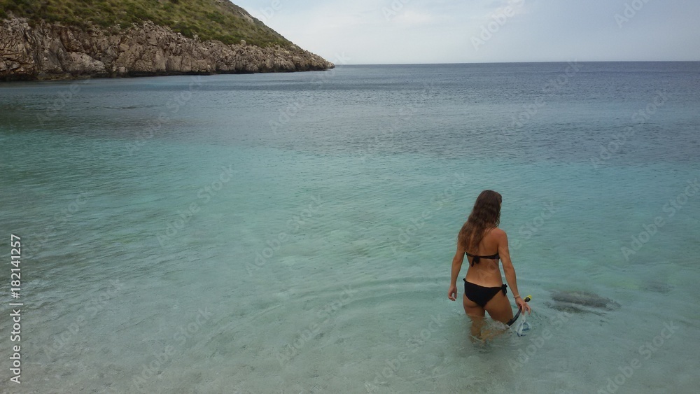 Obraz premium a girl explores the Zingaro nature reserve on Sicily island in Italy