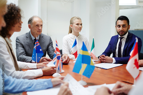 Group of confident politicians taking part in international event of political representatives photo