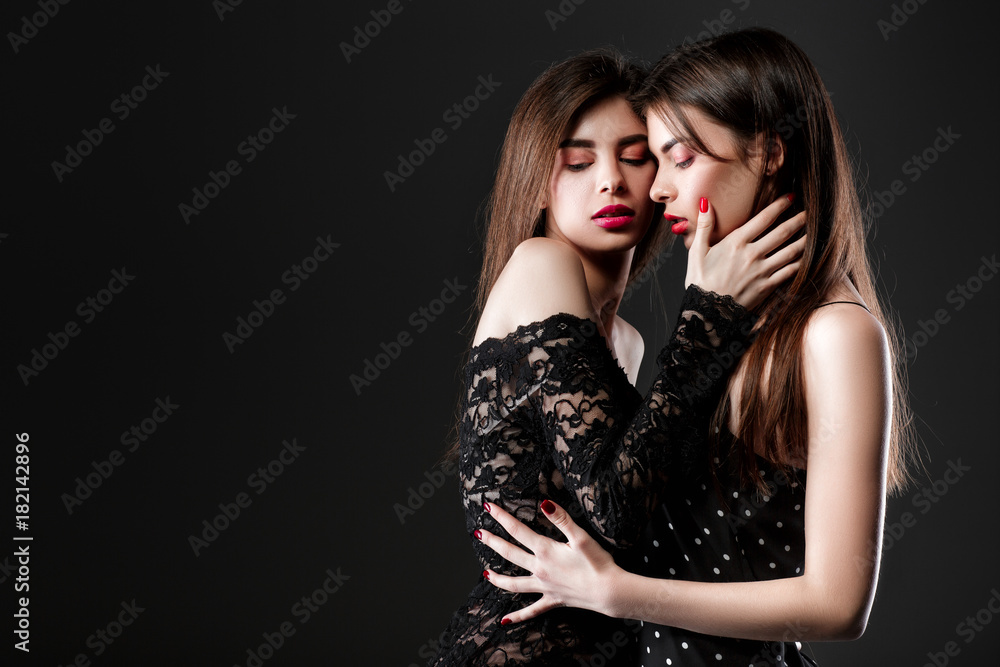two women in a black dress. Twins