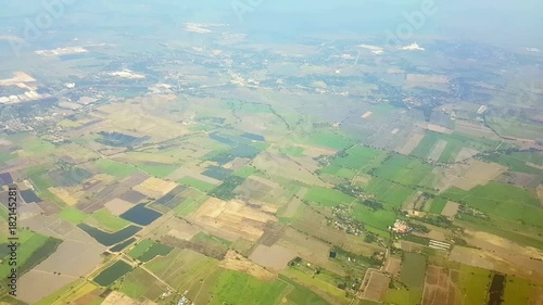 Aerial view on green country area with field patches