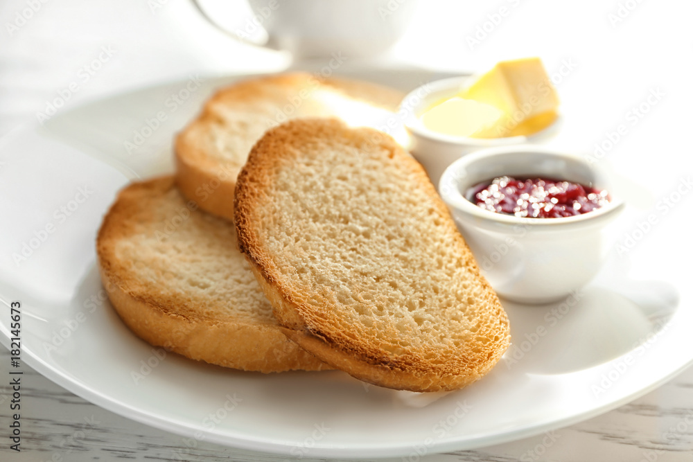 Plate with fresh crispy toasts on table Plate with fresh crispy toasts on table