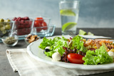 Plate with fresh vegetable salad on table, closeup