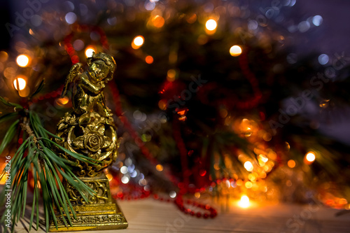 angel statue on christmas background with New Year's bokeh 