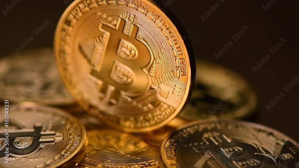 Bitcoin crypto currency. BTC coins on black background. Blockchain technology, Bitcoin mining concept. Rotation 360 degrees. 4K UHD video 3840x2160
