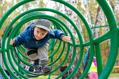boy playing at a children's playground photo