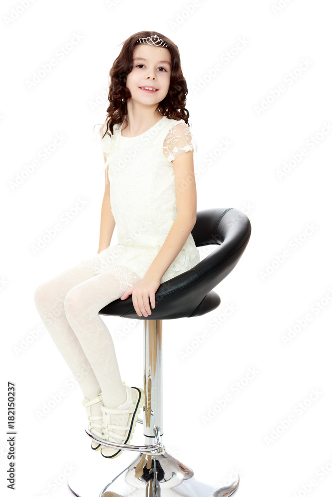 Little girl sitting in a swivel chair. Little girl sitting in a swivel chair.