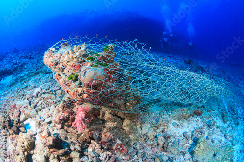 An abandoned fishing net (Ghost net) stuck on a tropical coral reef
