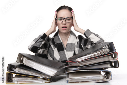 Female office worker  sitting at the desk with papers document. Tired and exhousted business woman. photo