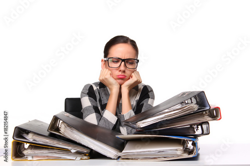 Female office worker  sitting at the desk with papers document. Tired and exhousted business woman. photo