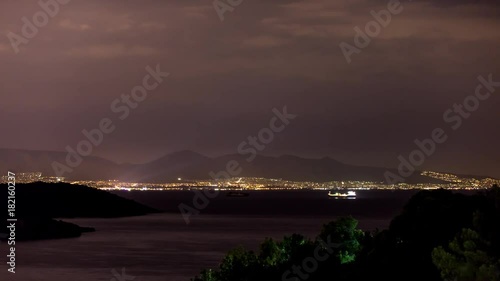 4K Timelapse at Salamina Island by night with airplane photo