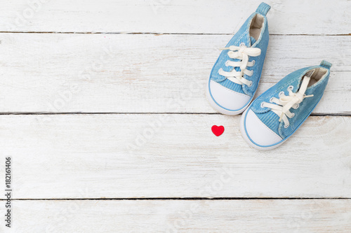 Children's sneakers for a boy of blue color and a red heart. Mockup