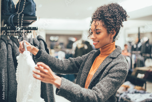 Black young woman doing shopping in a store