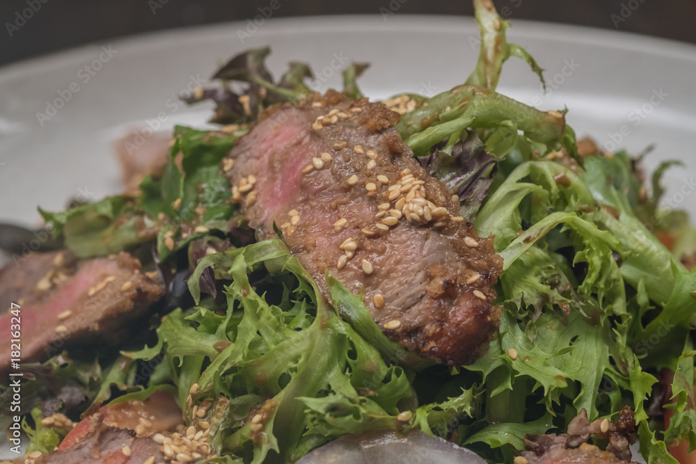 Close up Roasted beef with herbed bread crust sliced and vegetable. (selective focus)