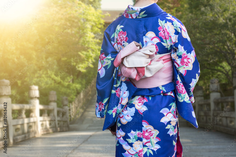 Women in traditional japanese kimonos walking at temple with sunset in Kyoto, Japan Women in traditional japanese kimonos walking at temple with sunset in Kyoto, Japan
