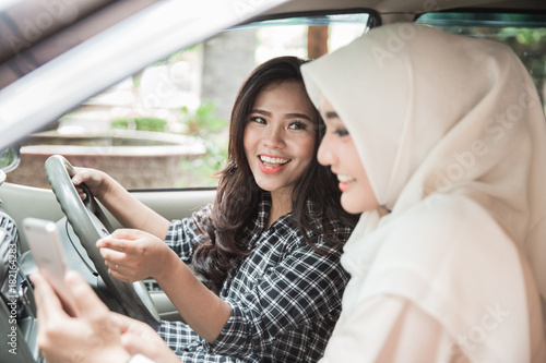 two young asian woman in the car