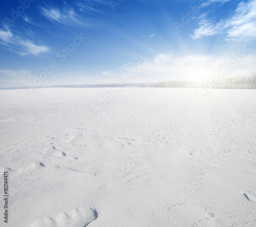  Snowcovered fields on blue sky © Alekss