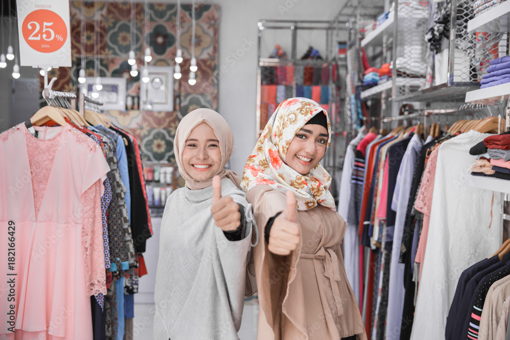 asian female fashion store owner showing thumb up asian female fashion store owner showing thumb up