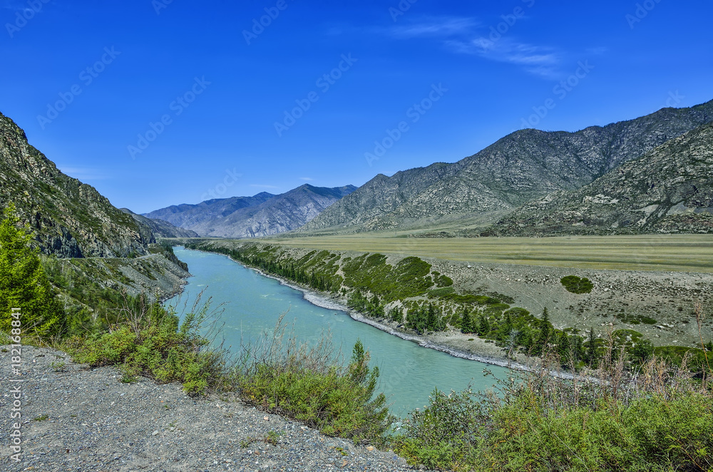Summer mountain landscape with turquoise river and colorful rocks